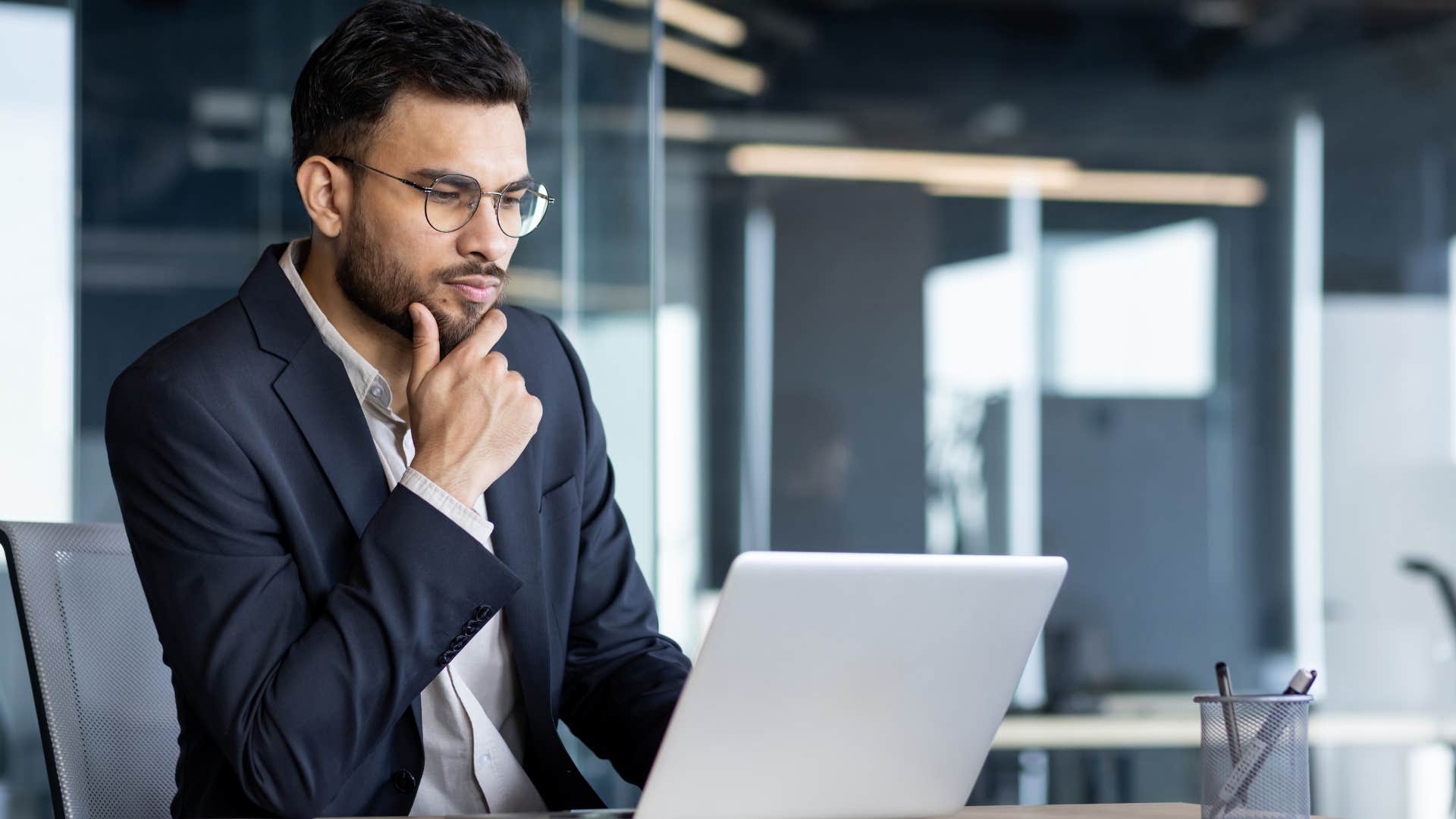 man storing information mentally looking at laptop