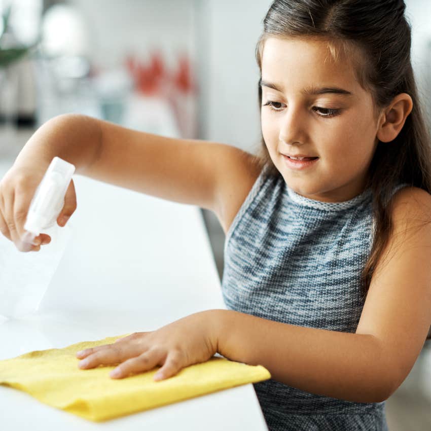Little girl doing household chores at home.