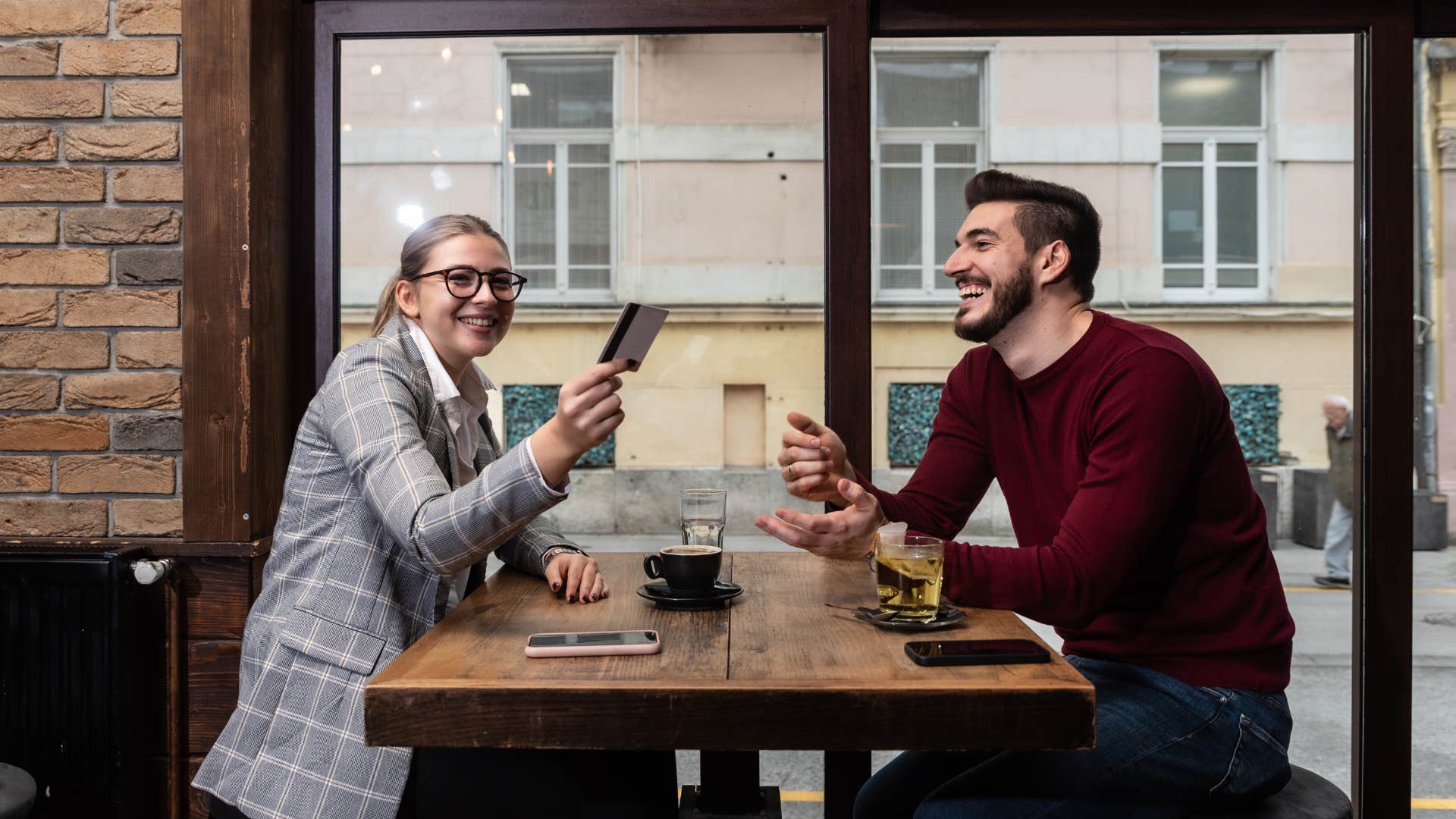 woman who is infatuated as she pays for man's meals