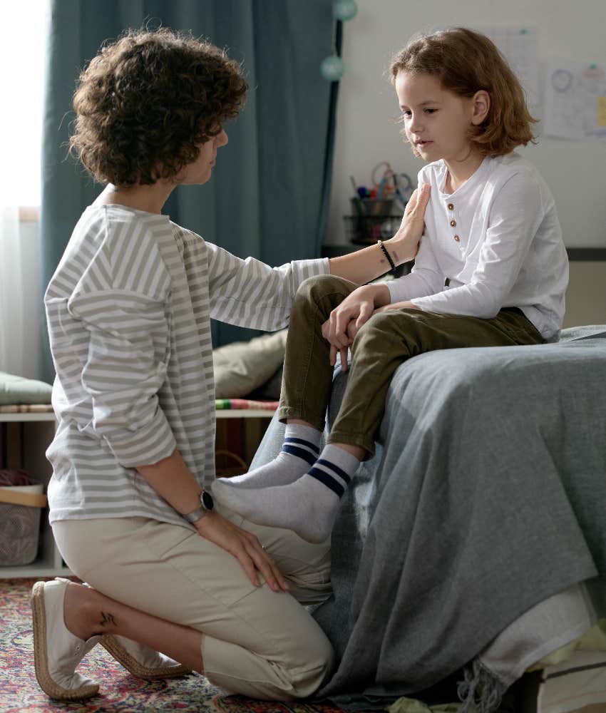 mom explaining decisions to child sitting on bed