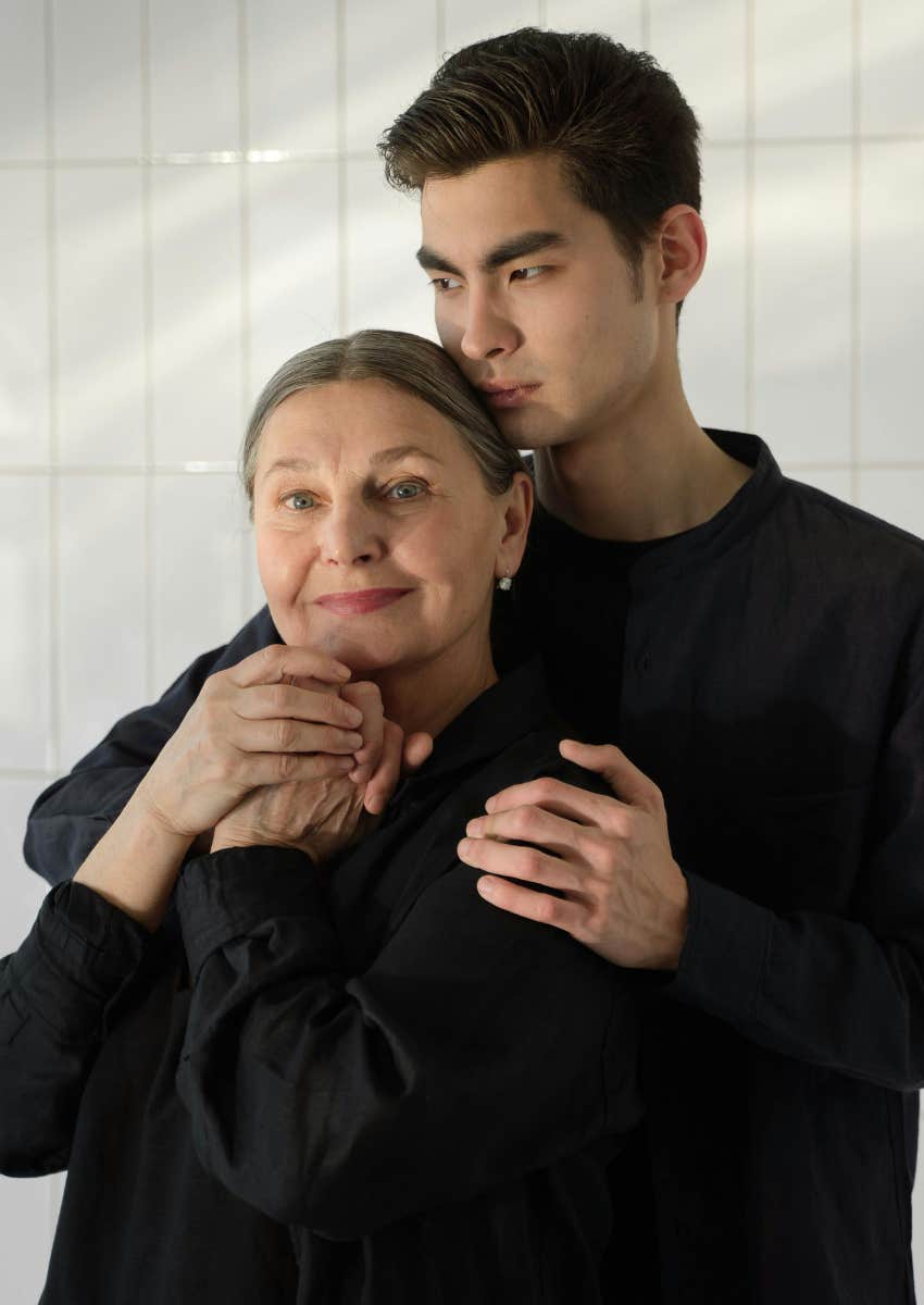 teenage son kissing his mom on the head