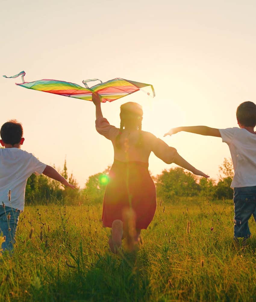 Excited children run with kite showing skill to build strong family