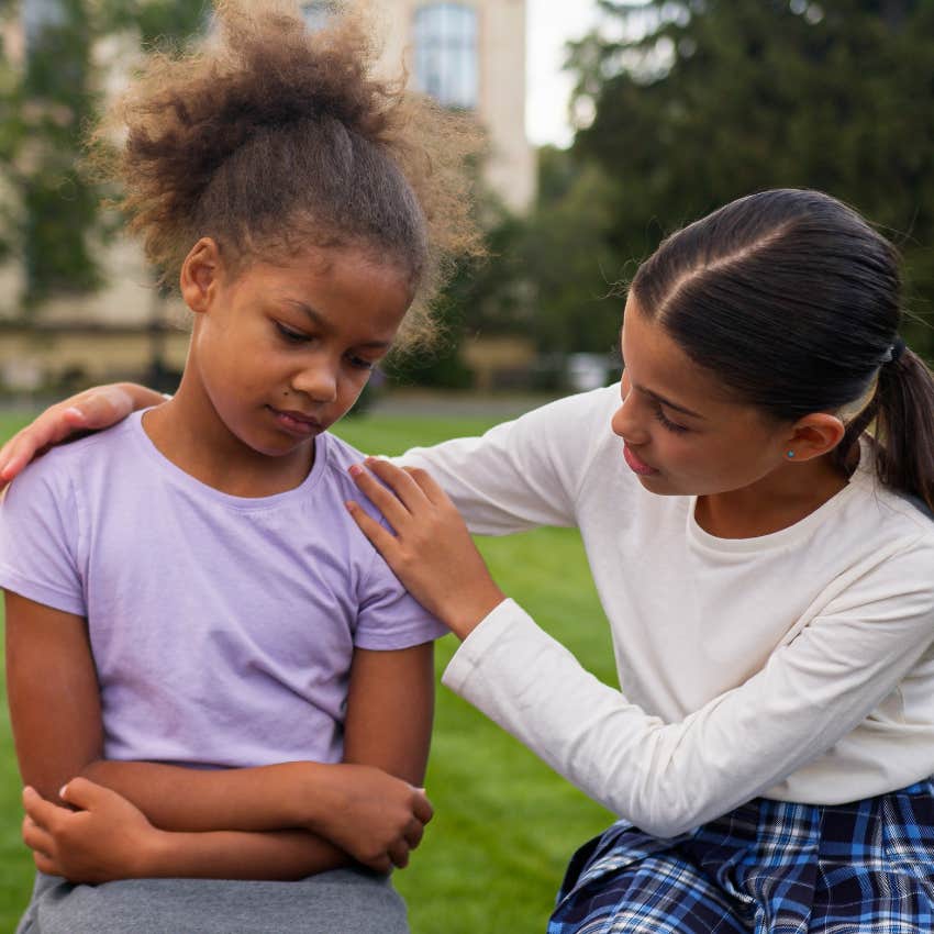 little girls apologizing to each other while playing outside