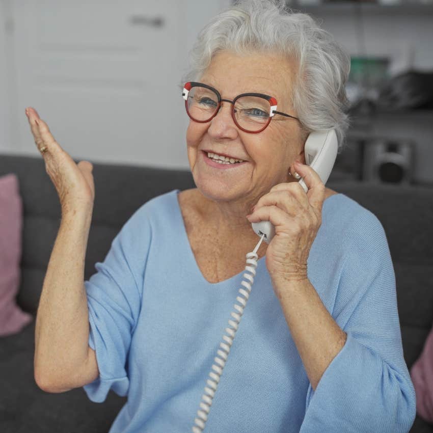 Woman sharing a family phone at home