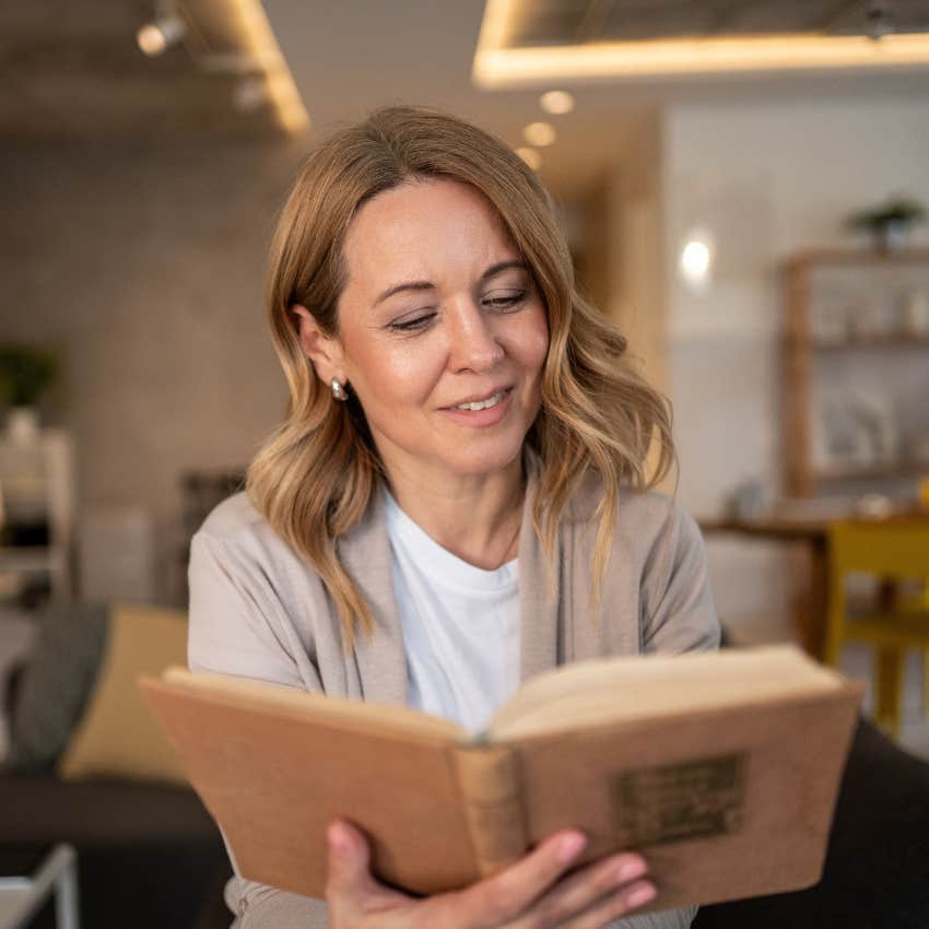 Woman accepting boredom by reading a book.