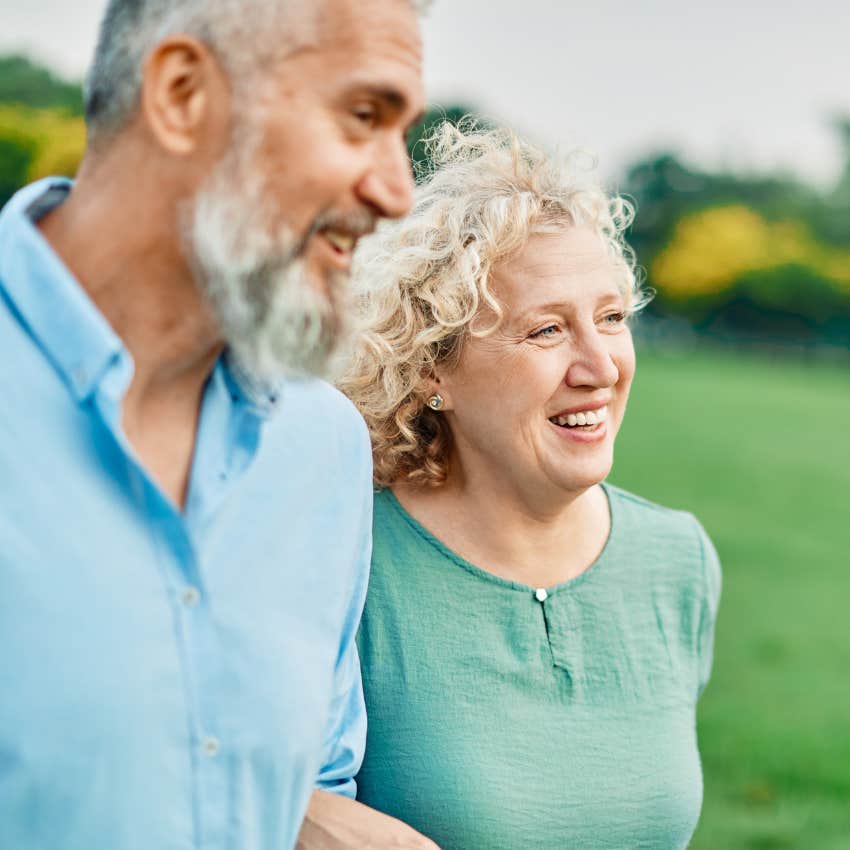 Woman appreciating nature on a walk outside with her husband.