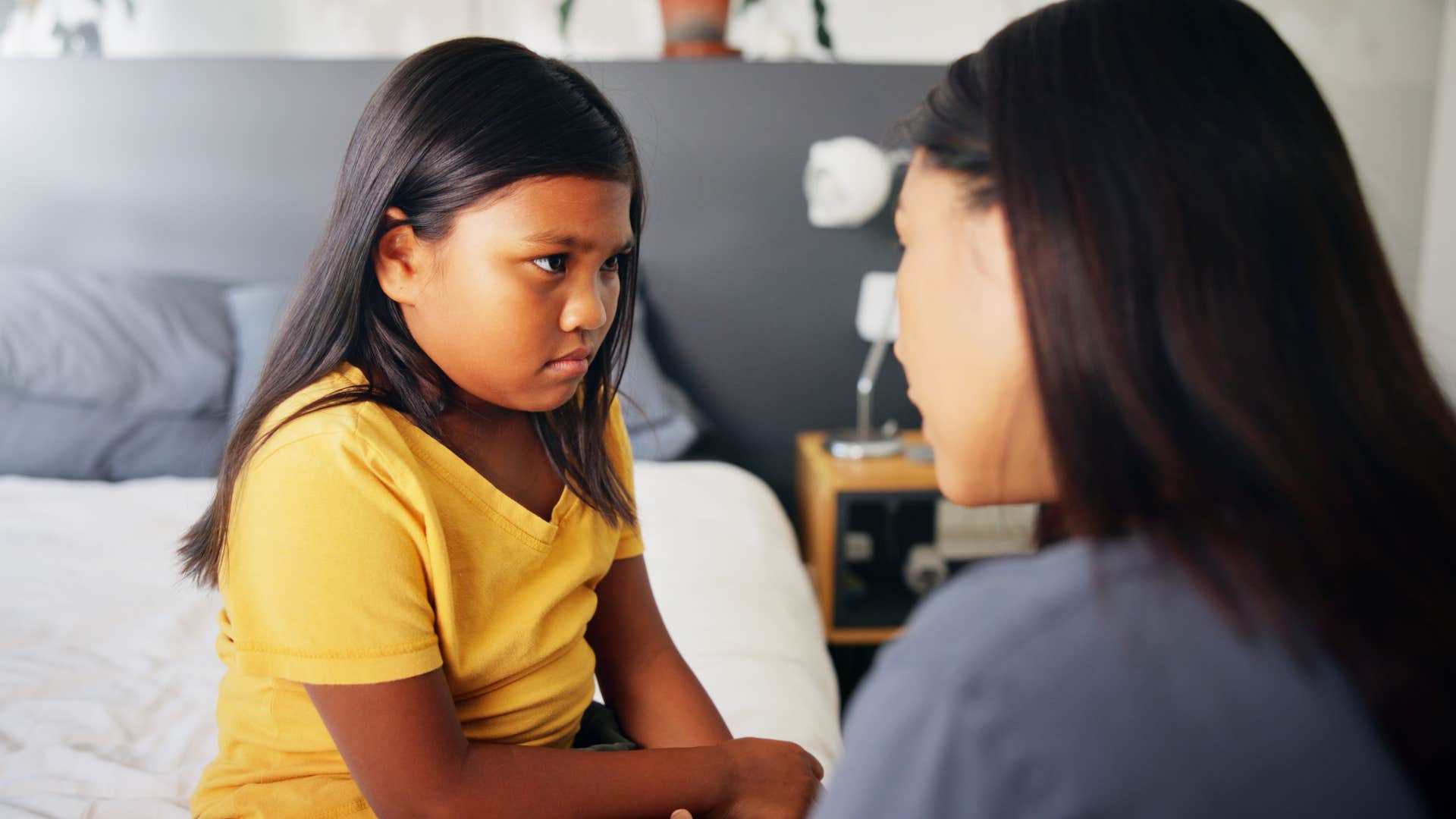 mom having serious talk with child about talking back