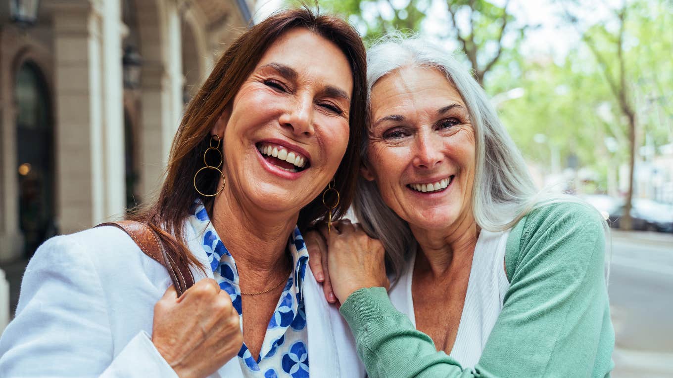 two friends from the 1970s hugging each other