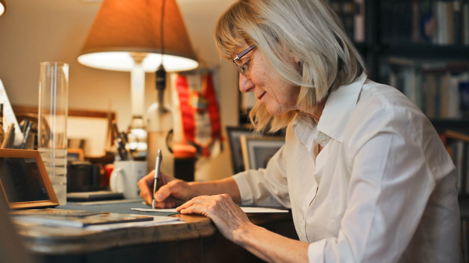 woman writing letter at her desk