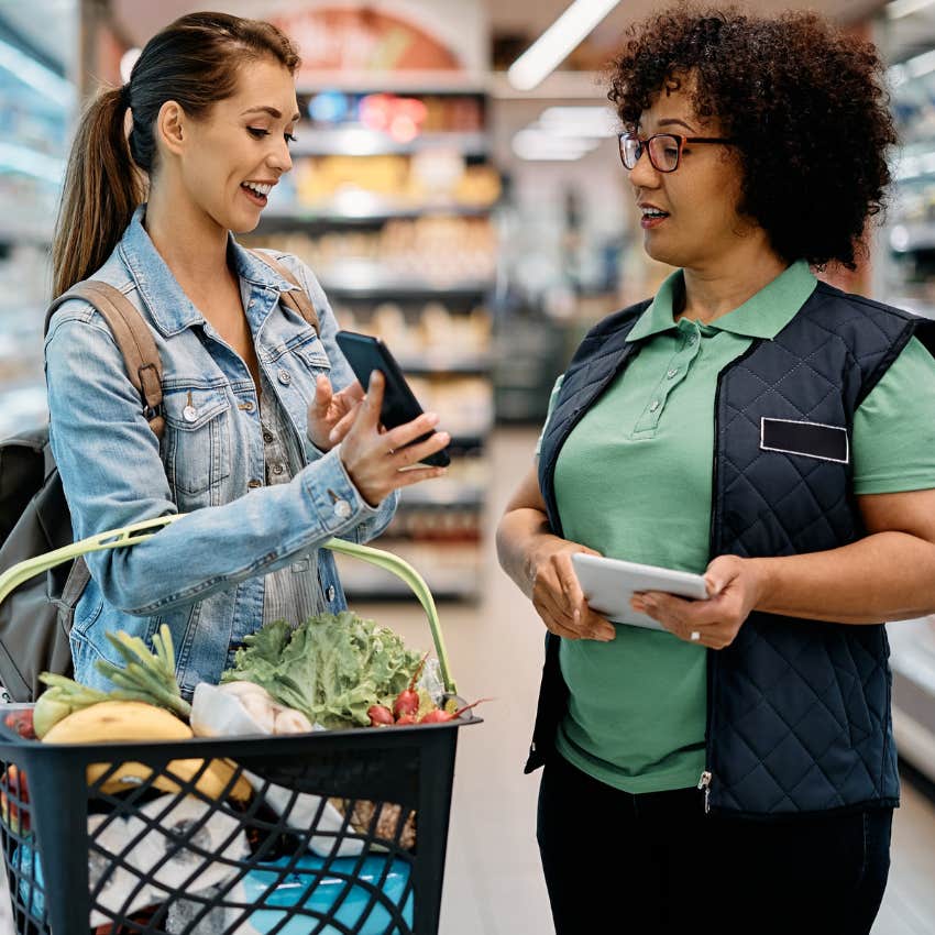 frugal woman comparing prices and using coupons while shopping