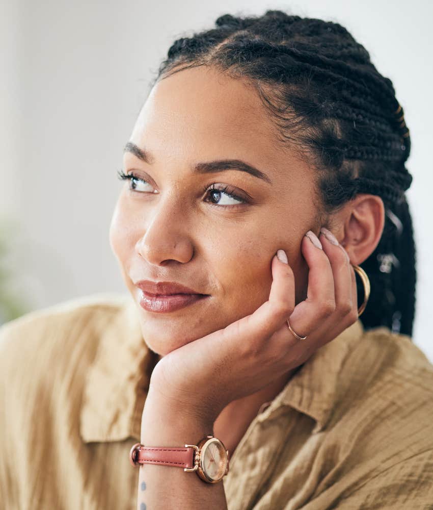Happy person rest head on hand showing alignment with self