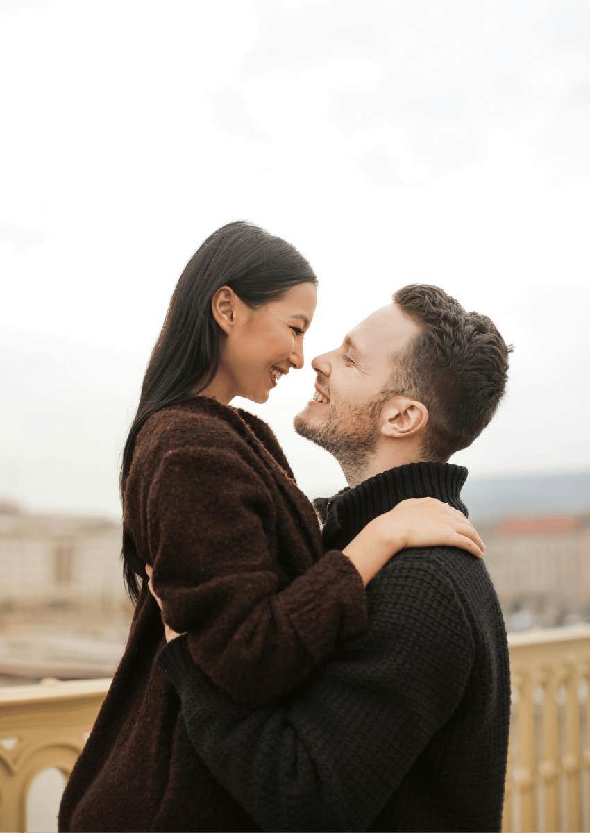 happy couple hugging close and staring into each other's eyes