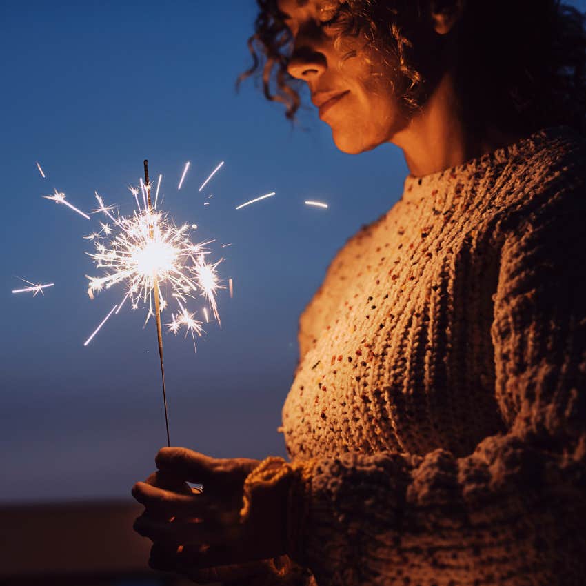 Woman honoring her ancestors to attract wealth and good fortune in 2026