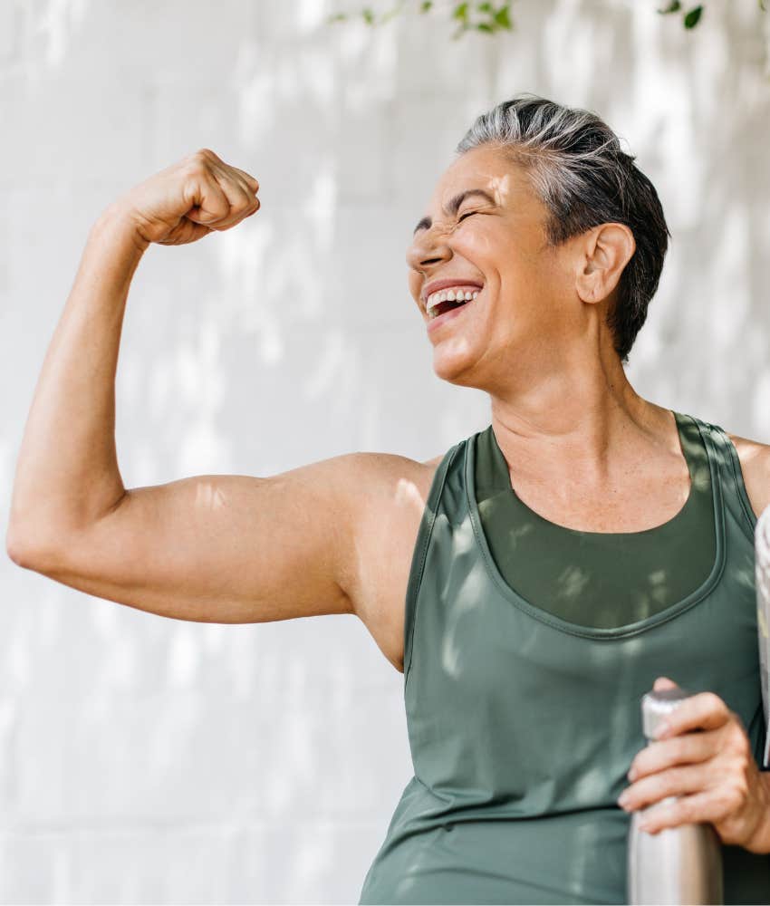 Joyful older person flexes bicep showing power in aging