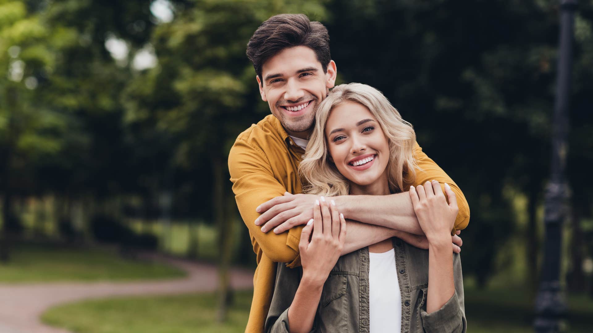 man hugging woman from behind after saying i'll always choose you