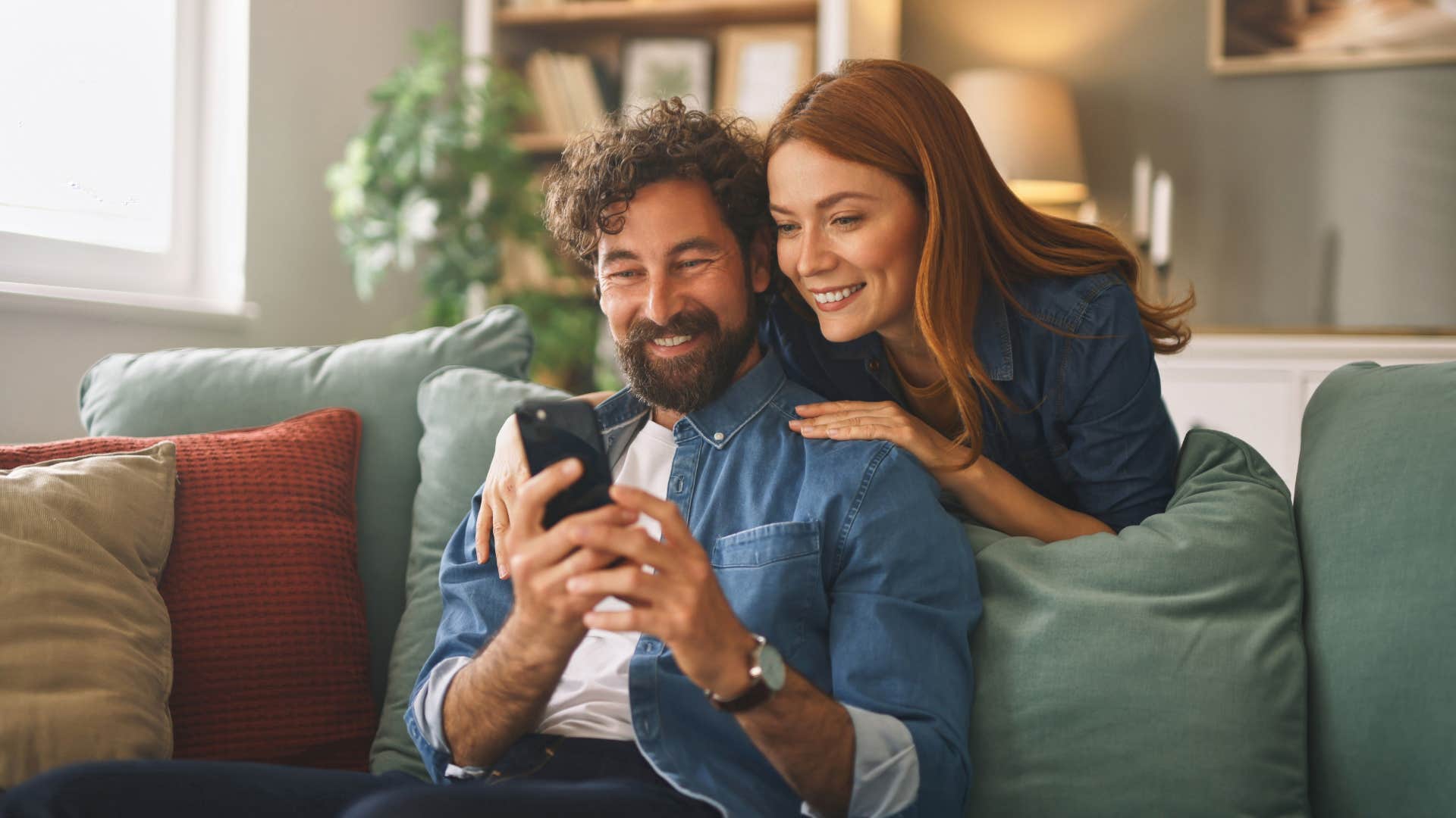 woman looking at man's phone saying i already mentioned you to them