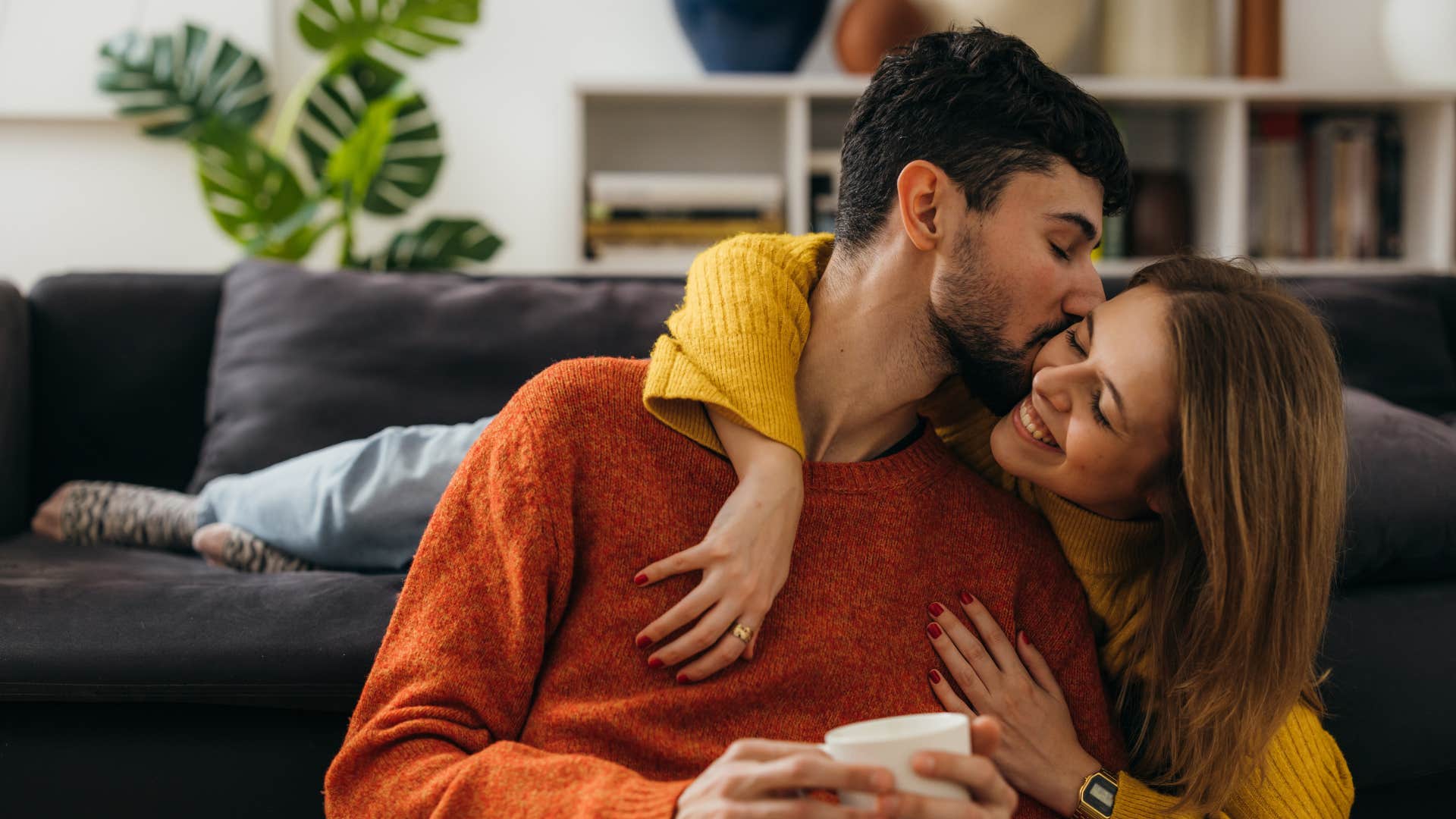 man kissing woman's cheek saying you're my first priority 