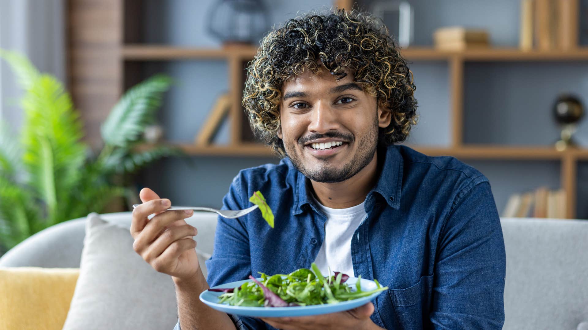 smiling man eating dinner alone without wife