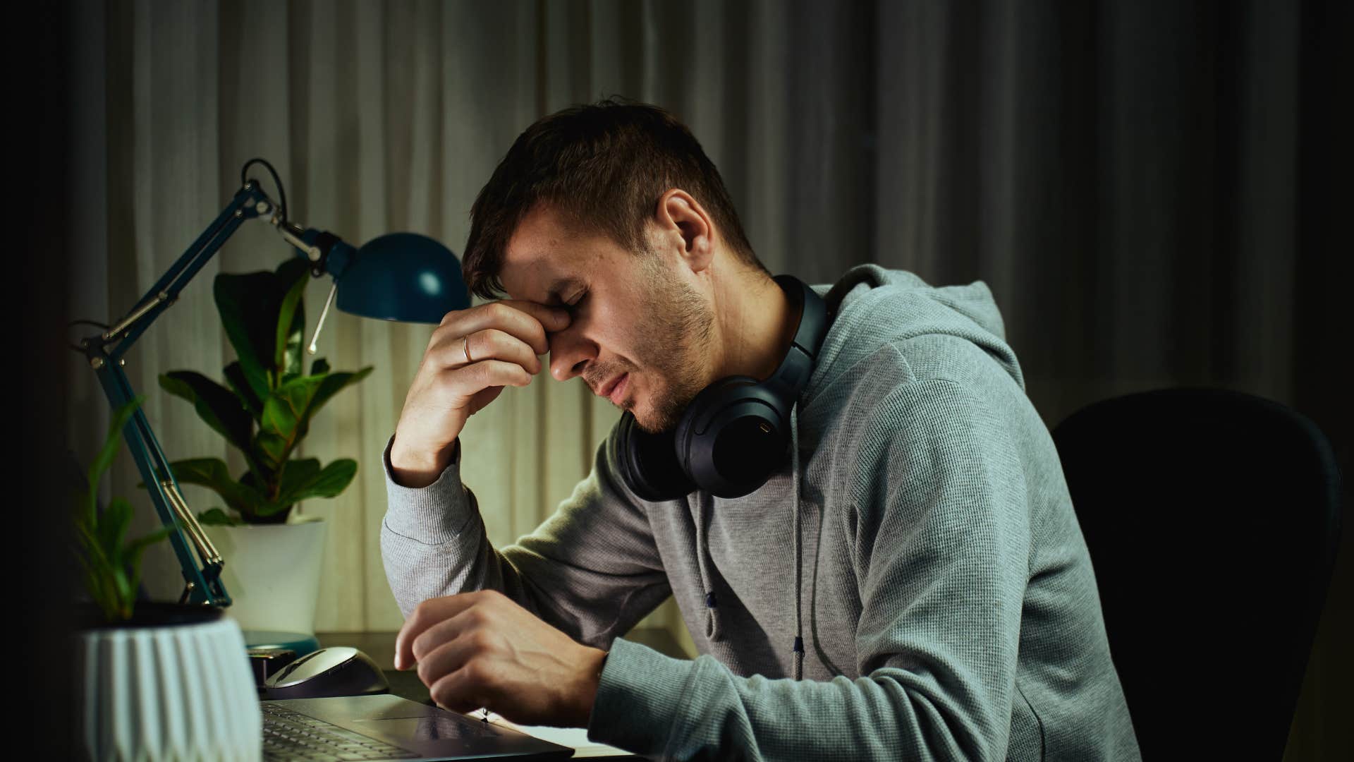 man working late hours as he avoids time at home