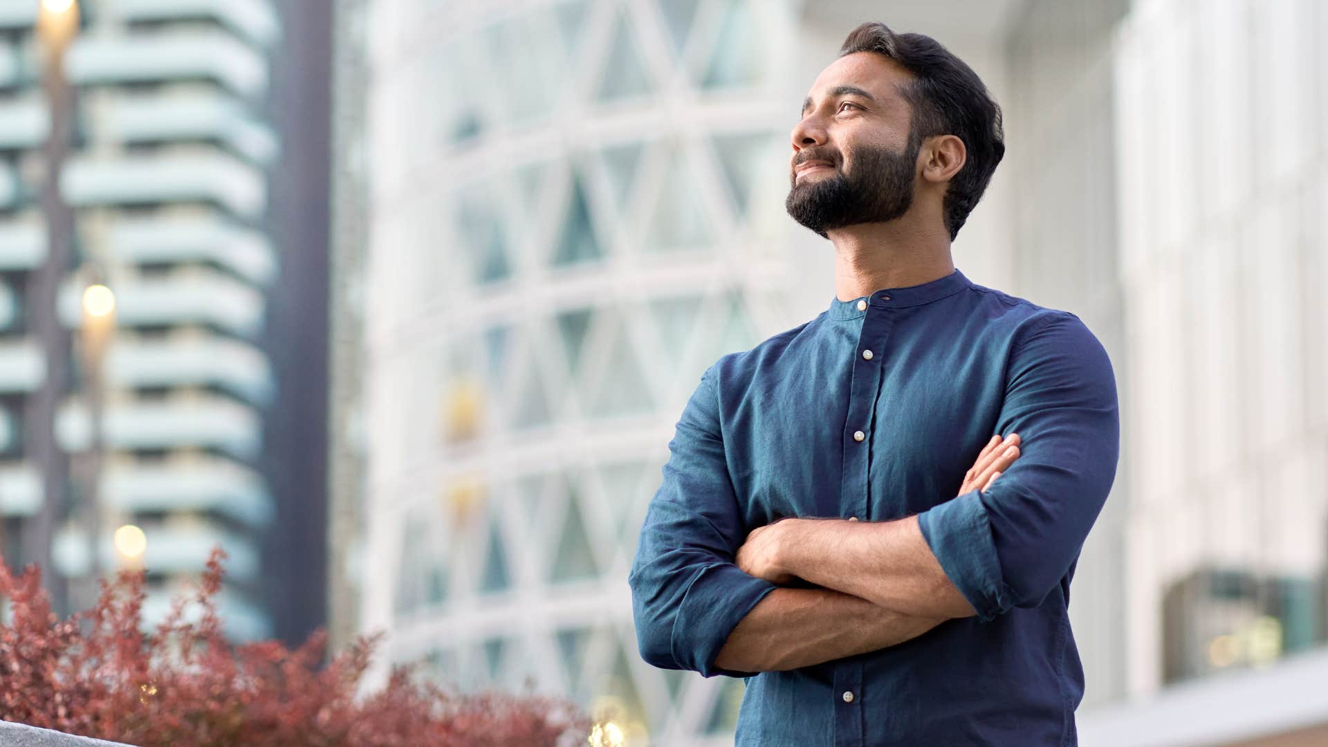 man in dark blue shirt crossing arms looking proud as he becomes overly independent