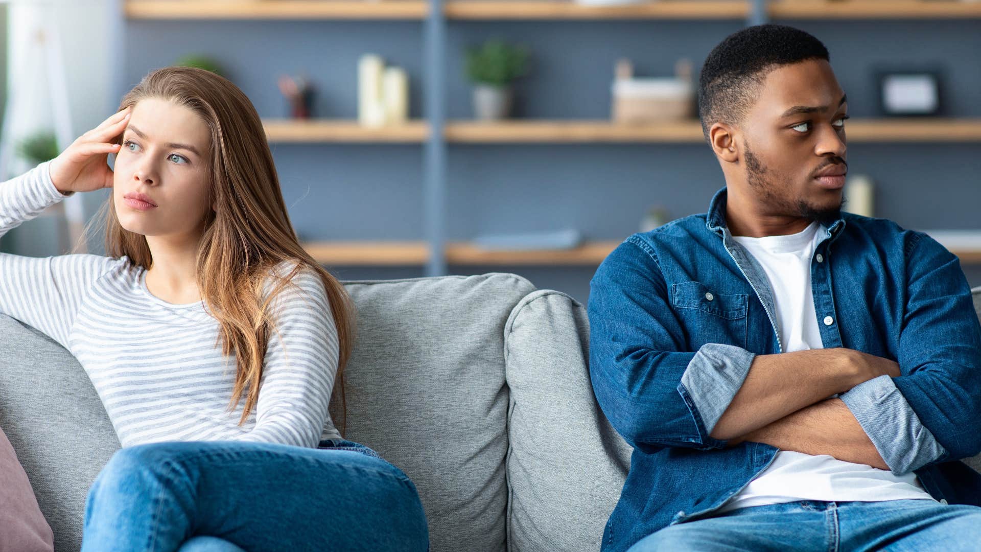 man irritated over small things as she ignores woman on couch