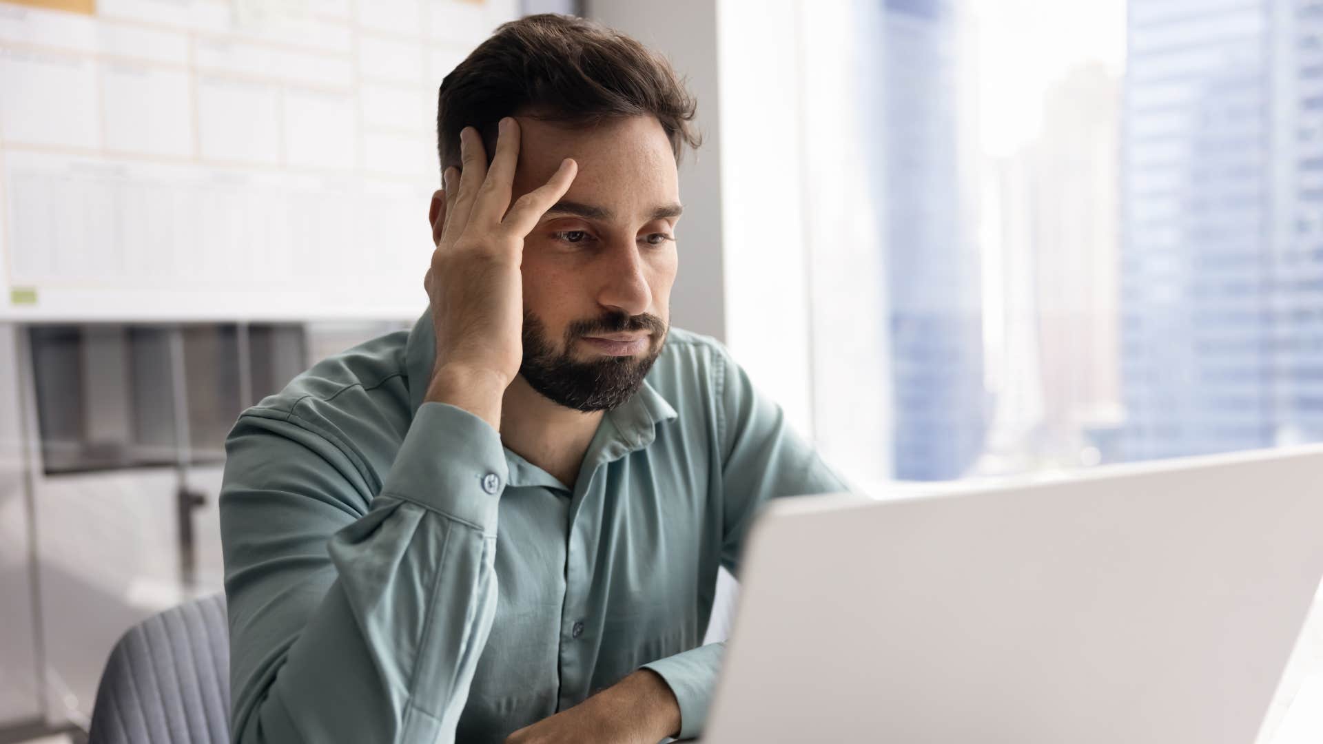 stressed man on laptop thinking i can't deal with this right now