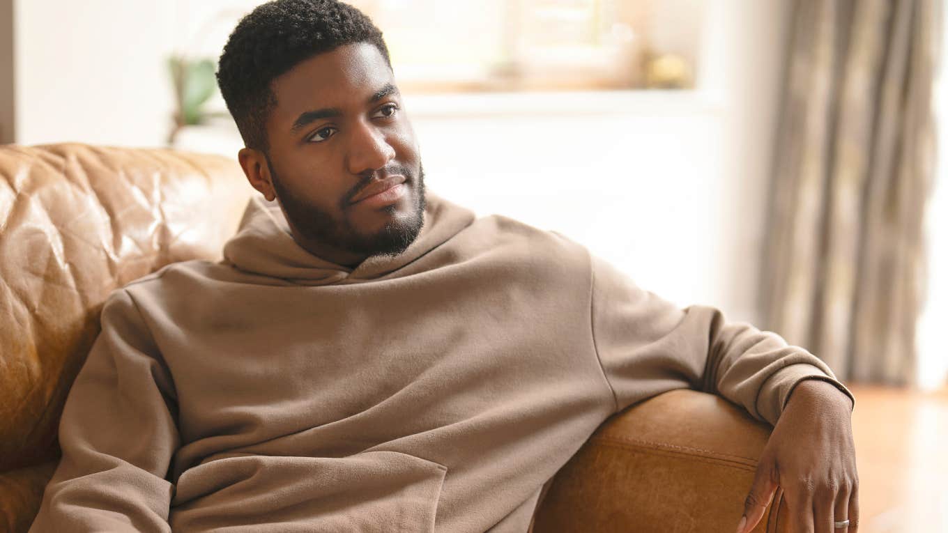 thoughtful man resting on the couch