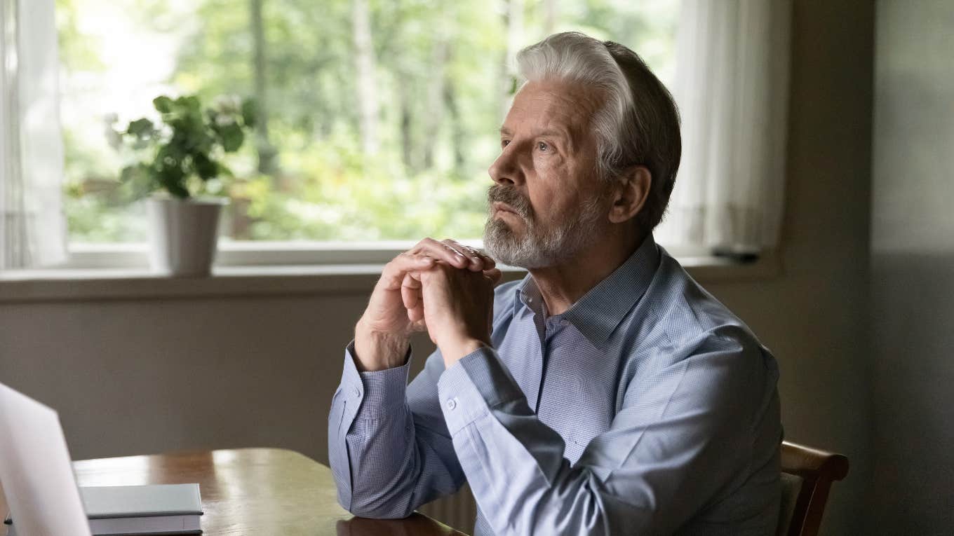man sitting at table thinking