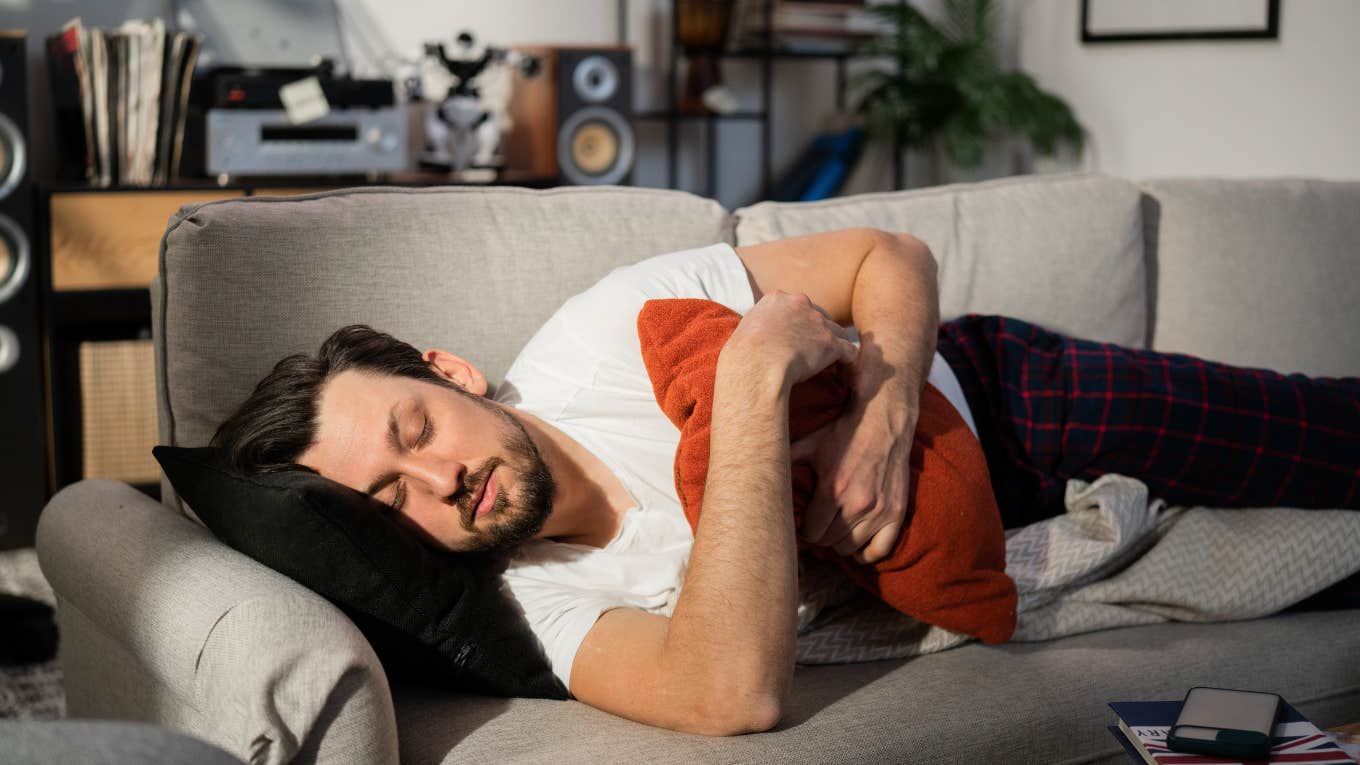 man sleeping on couch