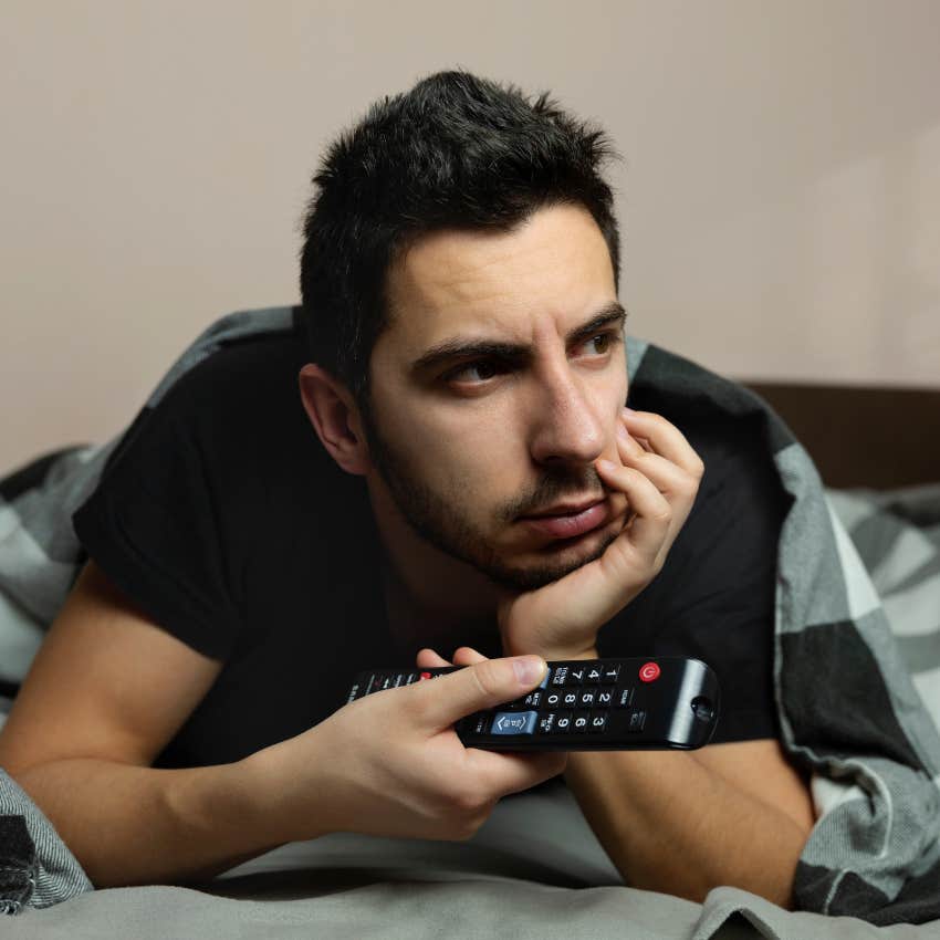 Man who goes to bed earlier or later than his partner watching TV