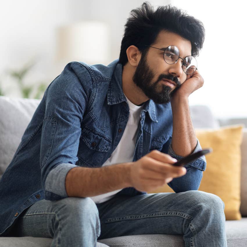 Man who overuses the TV sitting at home with the remote