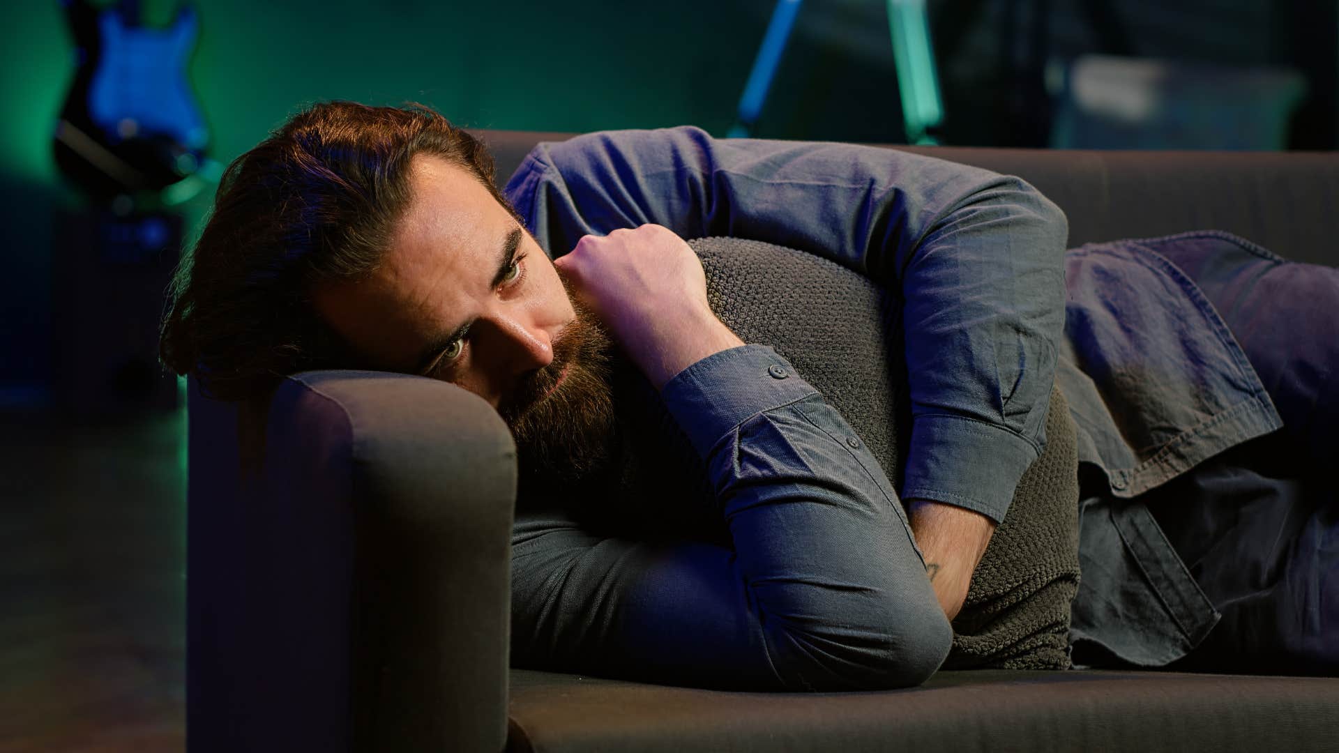 depressed man lying on couch