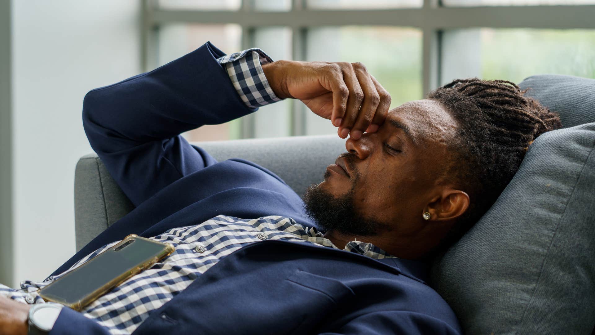 stressed man sleeping on the couch