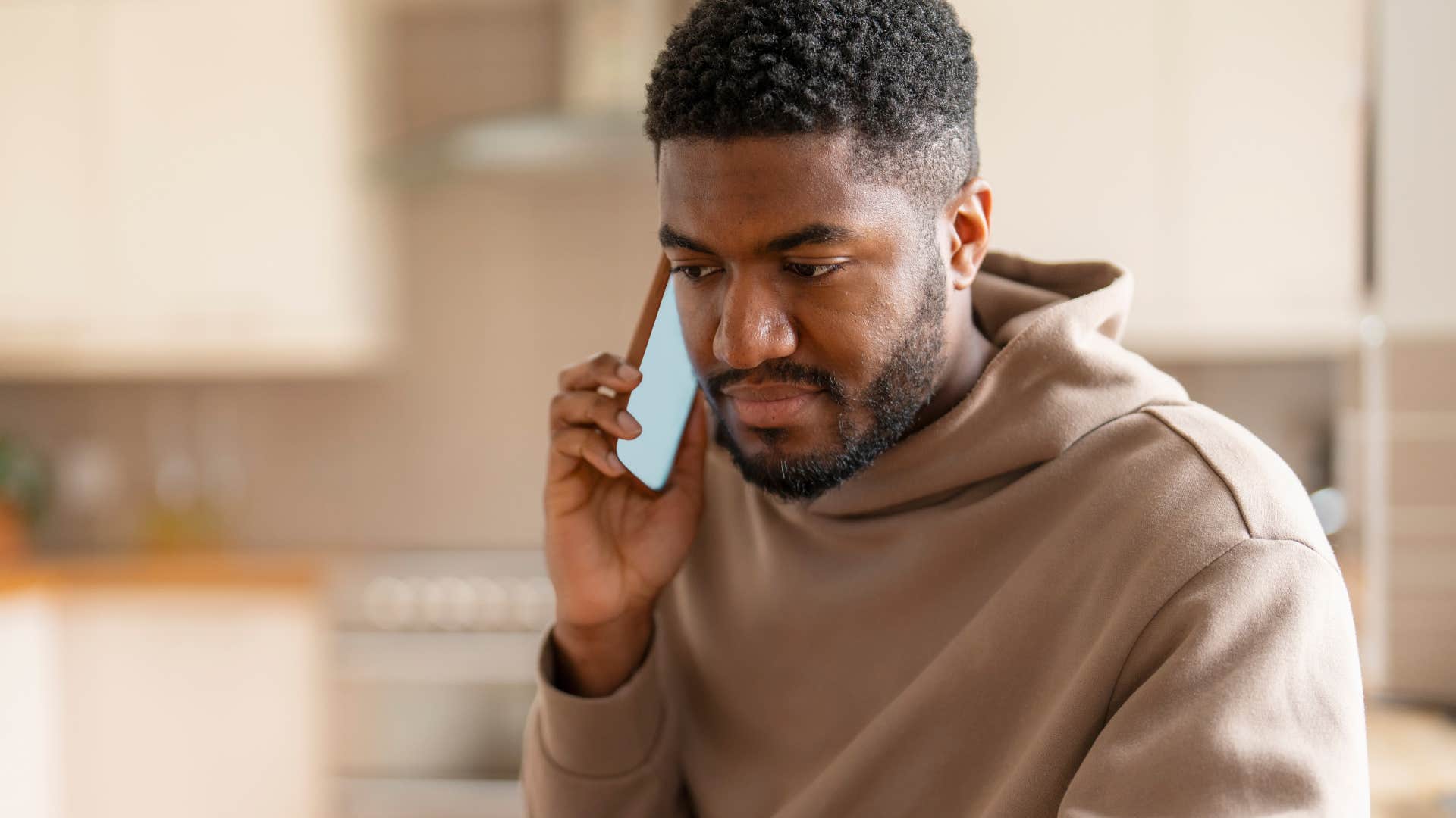 man having serious conversation on his phone