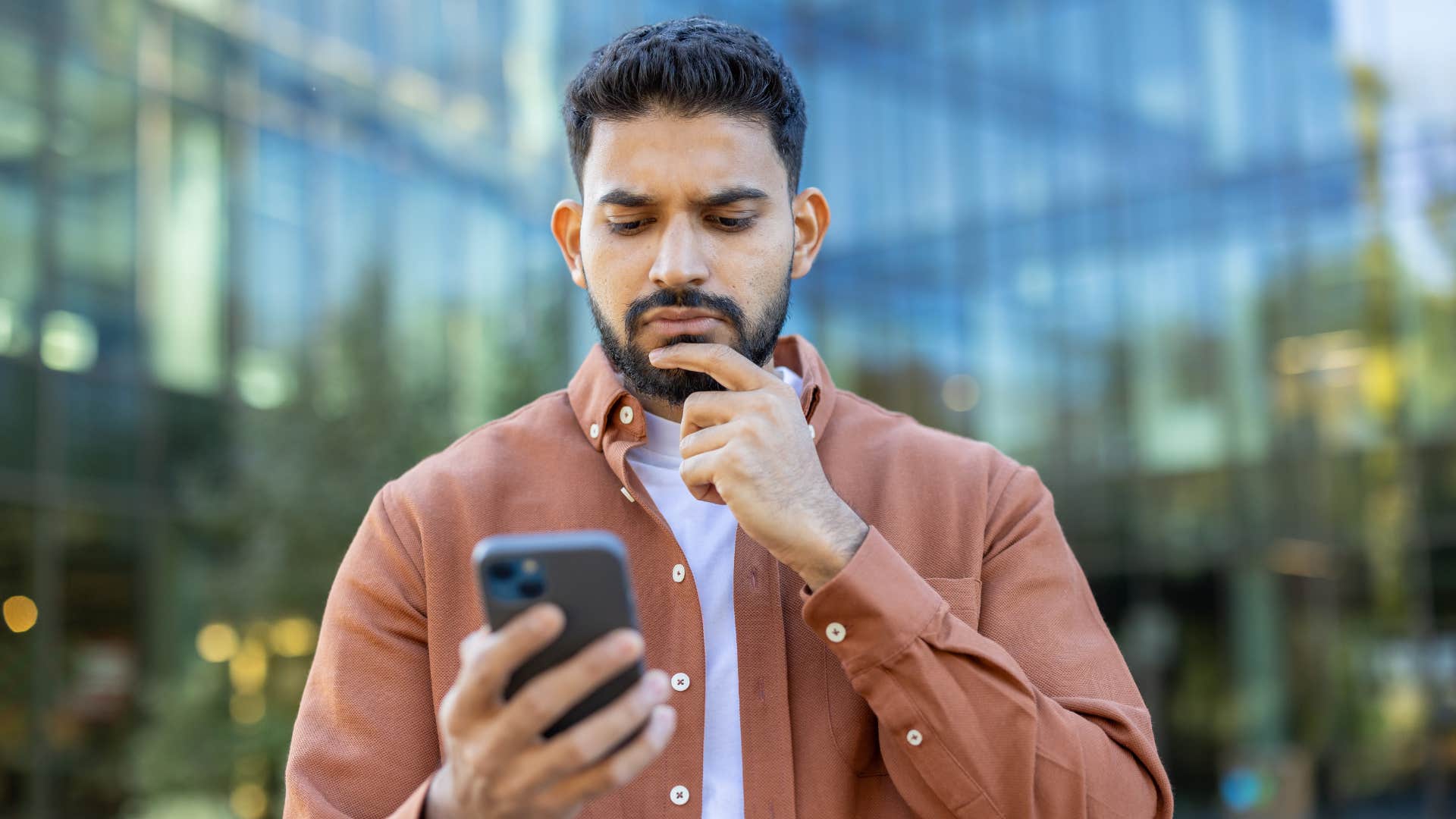 man considering something on his phone