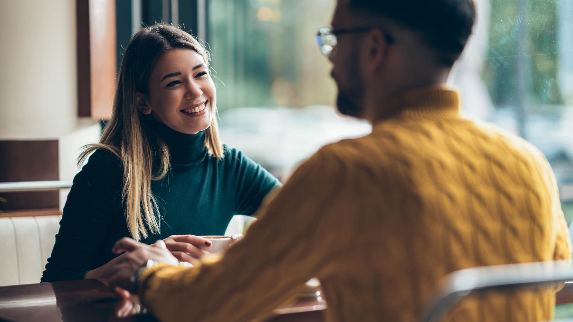 young couple sitting in a cafe and enjoying time together