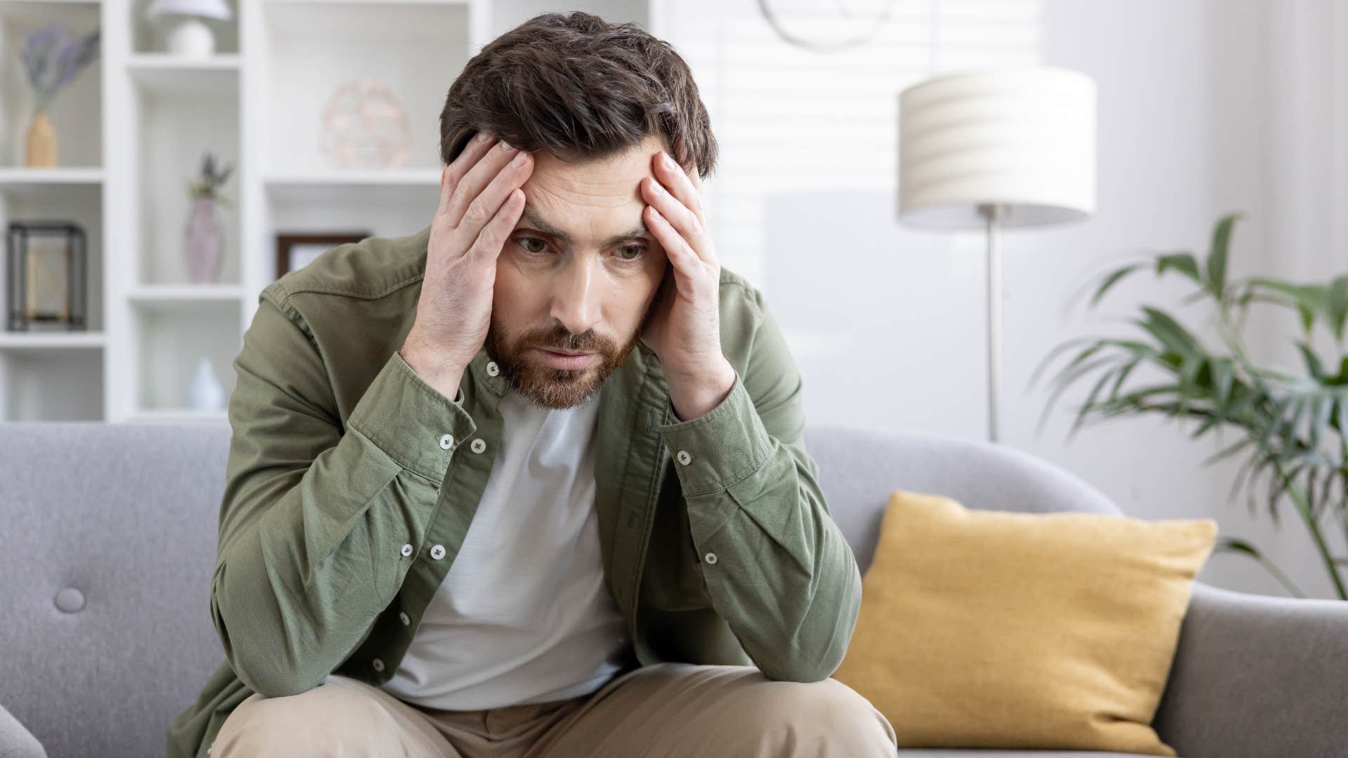 overwhelmed stressed man sitting at home