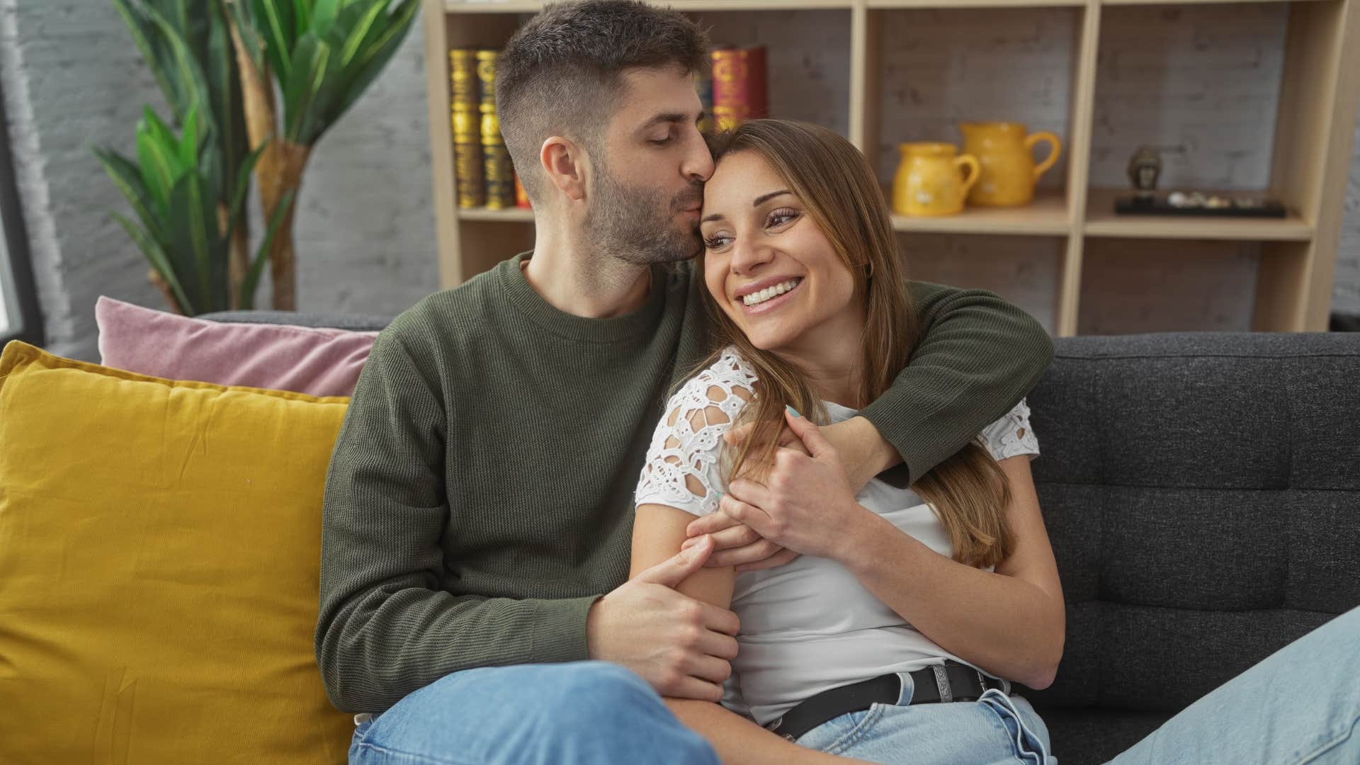 good man kissing woman's head showing affection