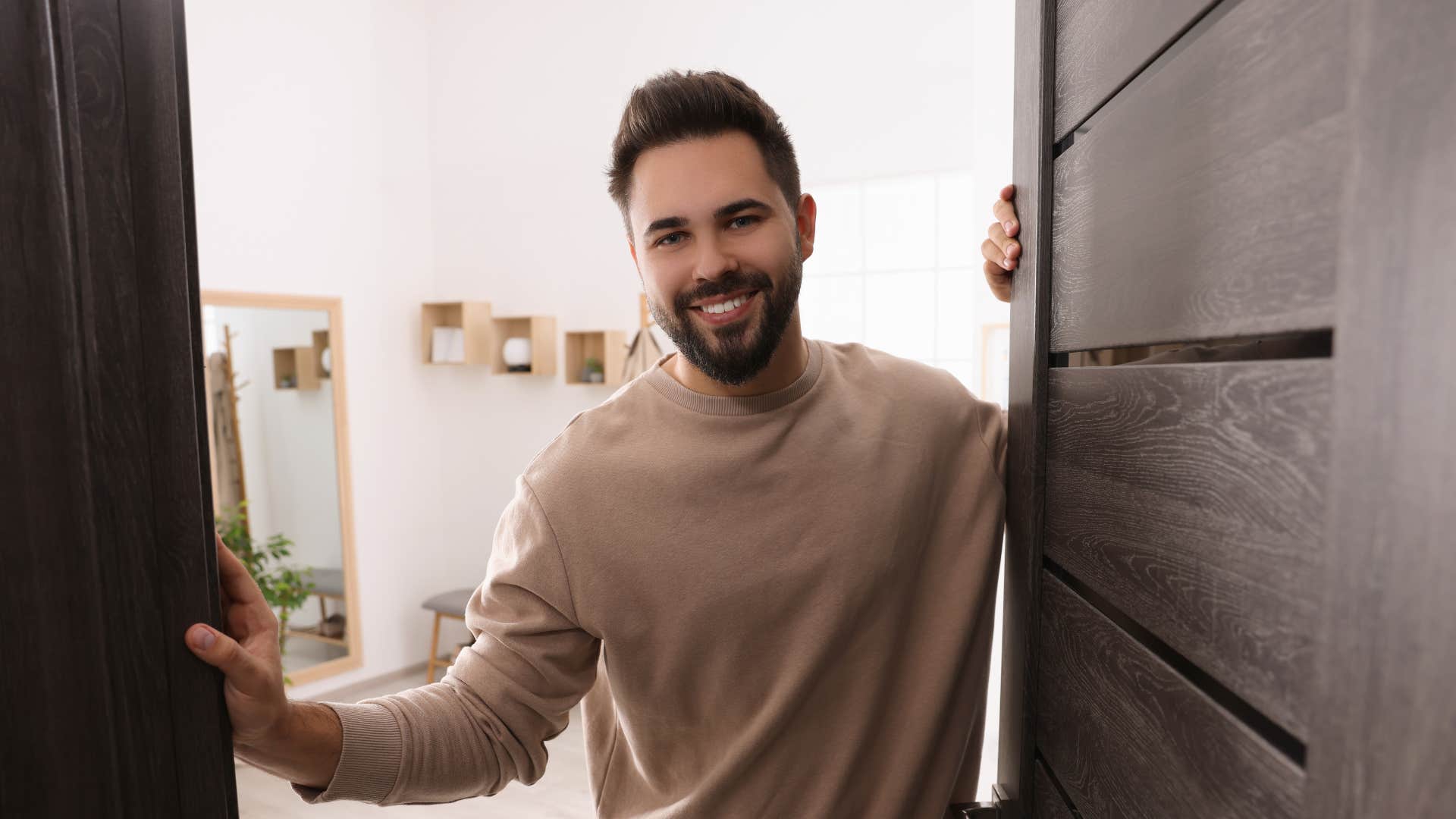 man opening the door offering a place to stay