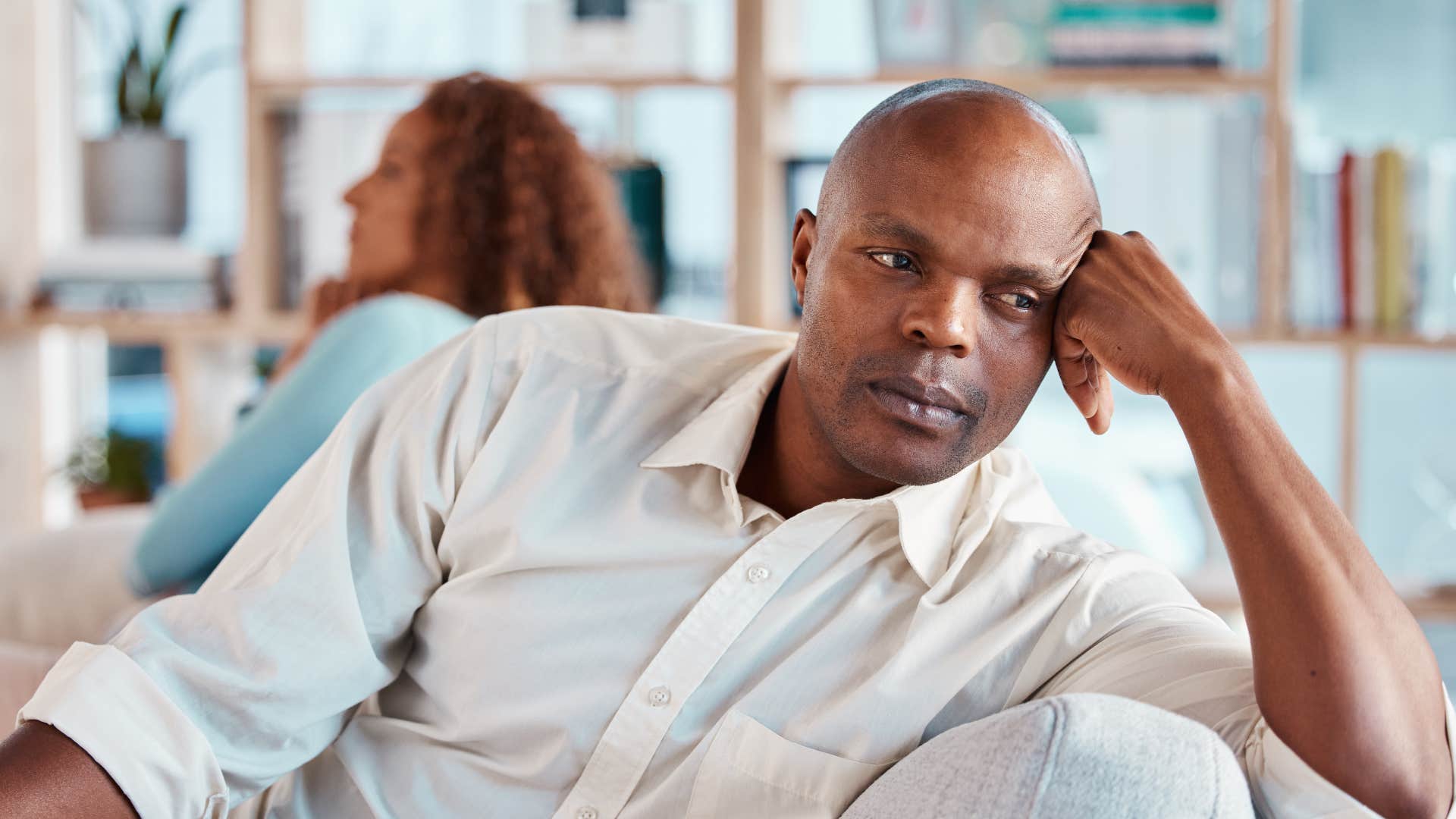 man thinking whatever sitting next to wife