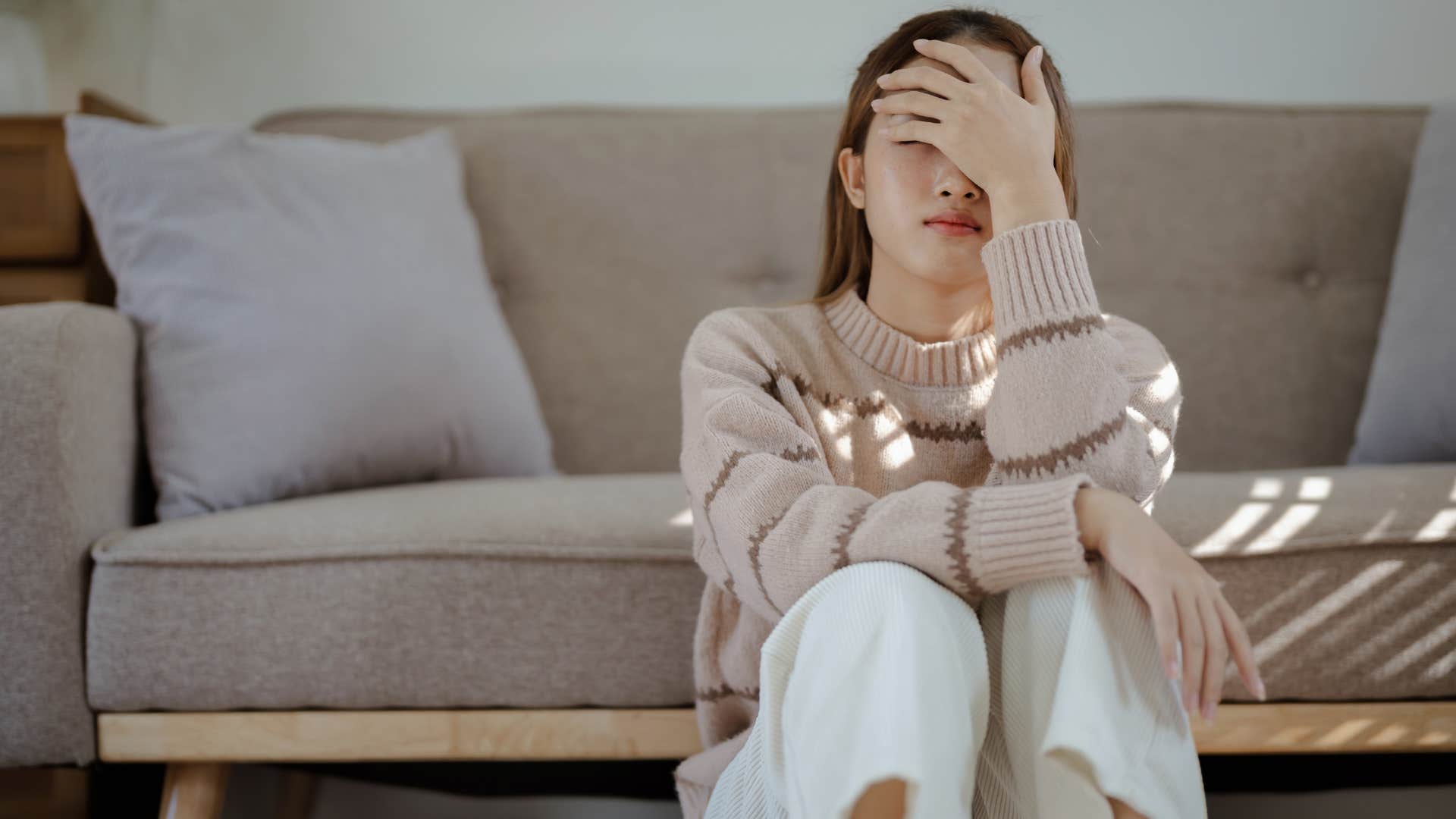 anxious woman who feels disconnected from little joys sitting alone