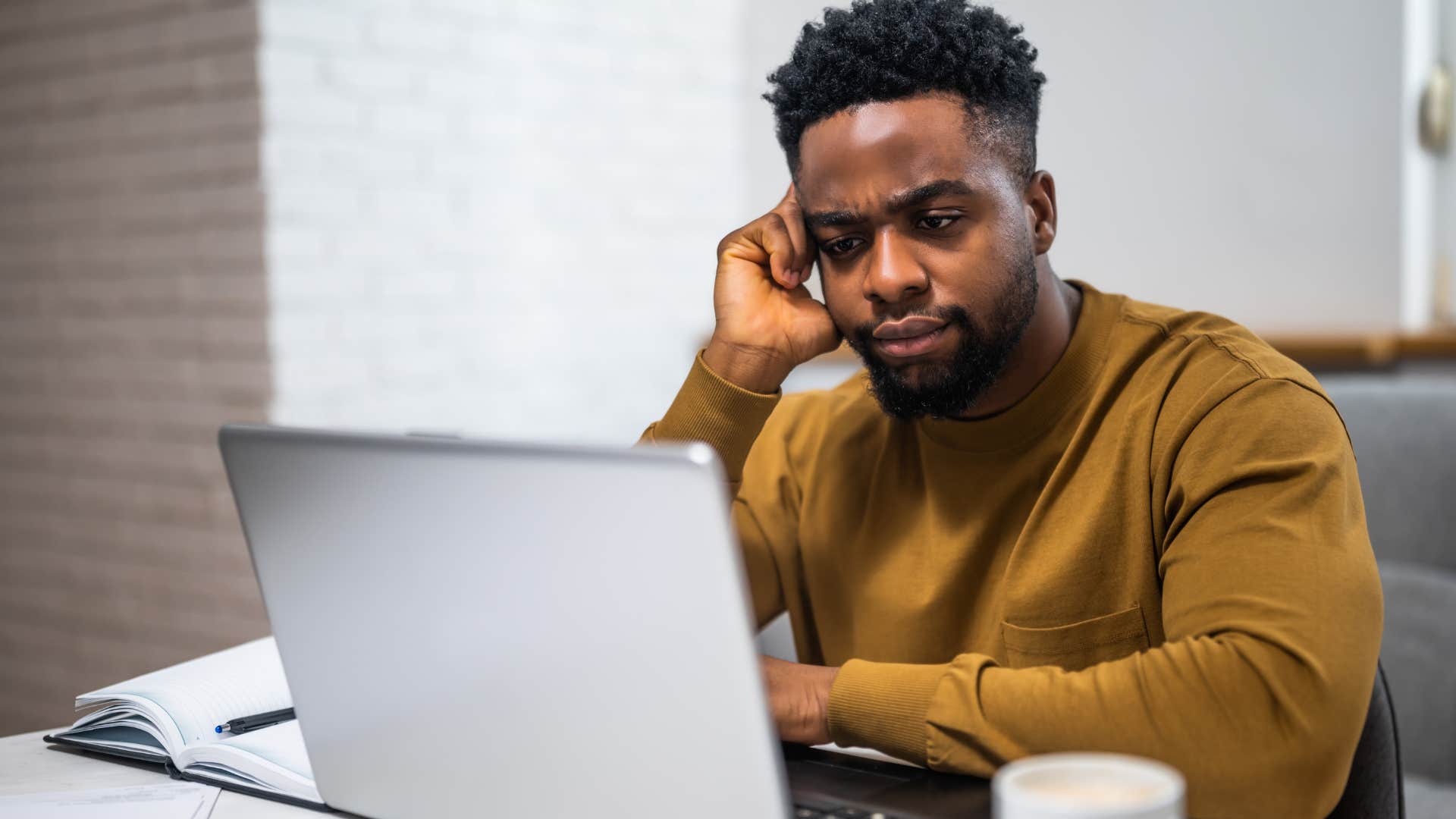 stressed man who was parentified from a young age sitting at home
