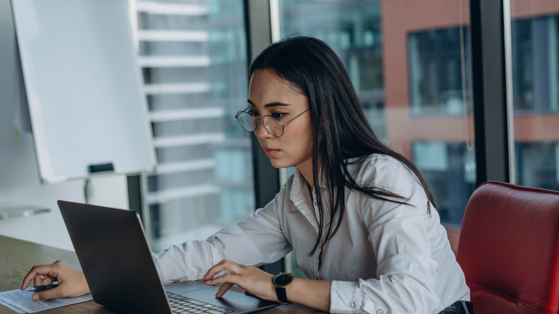 serious woman working on laptop doing her work right the first time