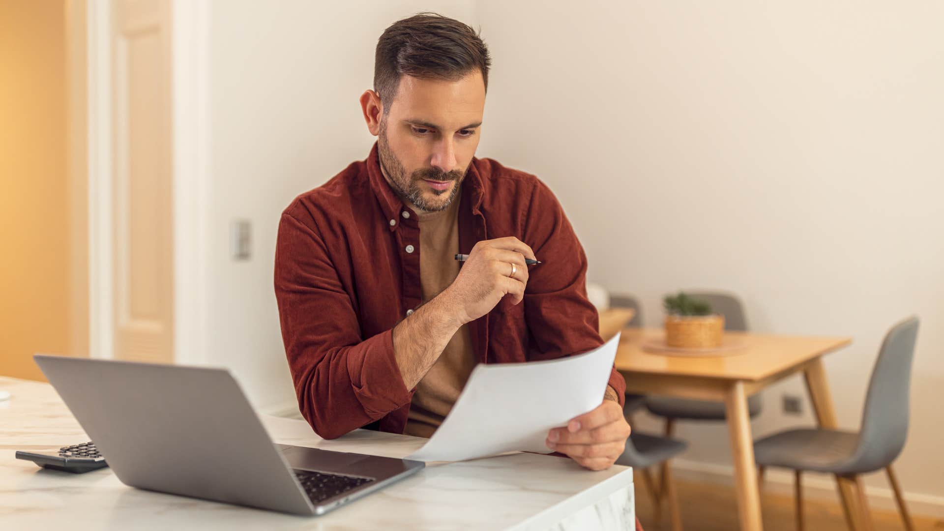 man looking at finances avoiding being reckless