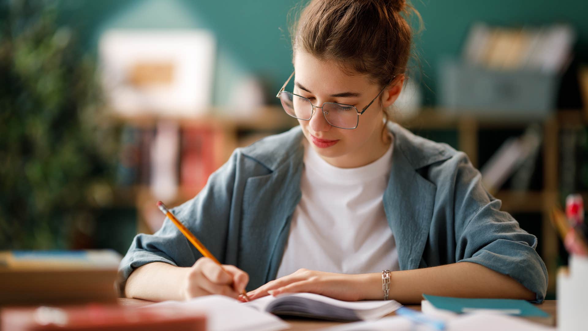 woman doing school work at desk