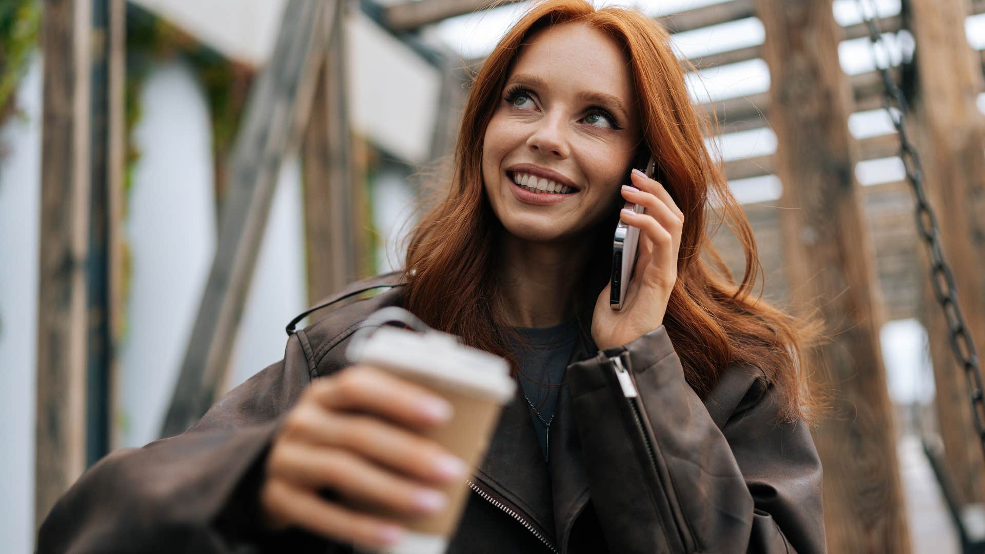 smiling woman saying I'm rooting for you on the phone to friend