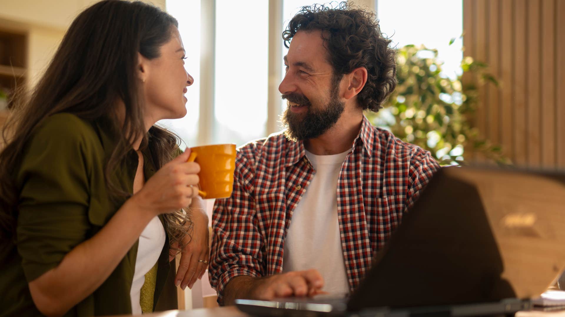happy couple having coffee together with man saying I'm really glad you're here
