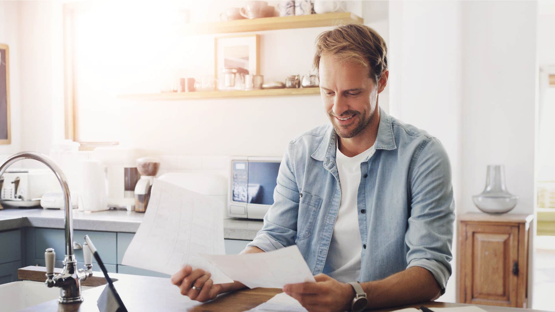 man working on an unfinished project at his kitchen counter