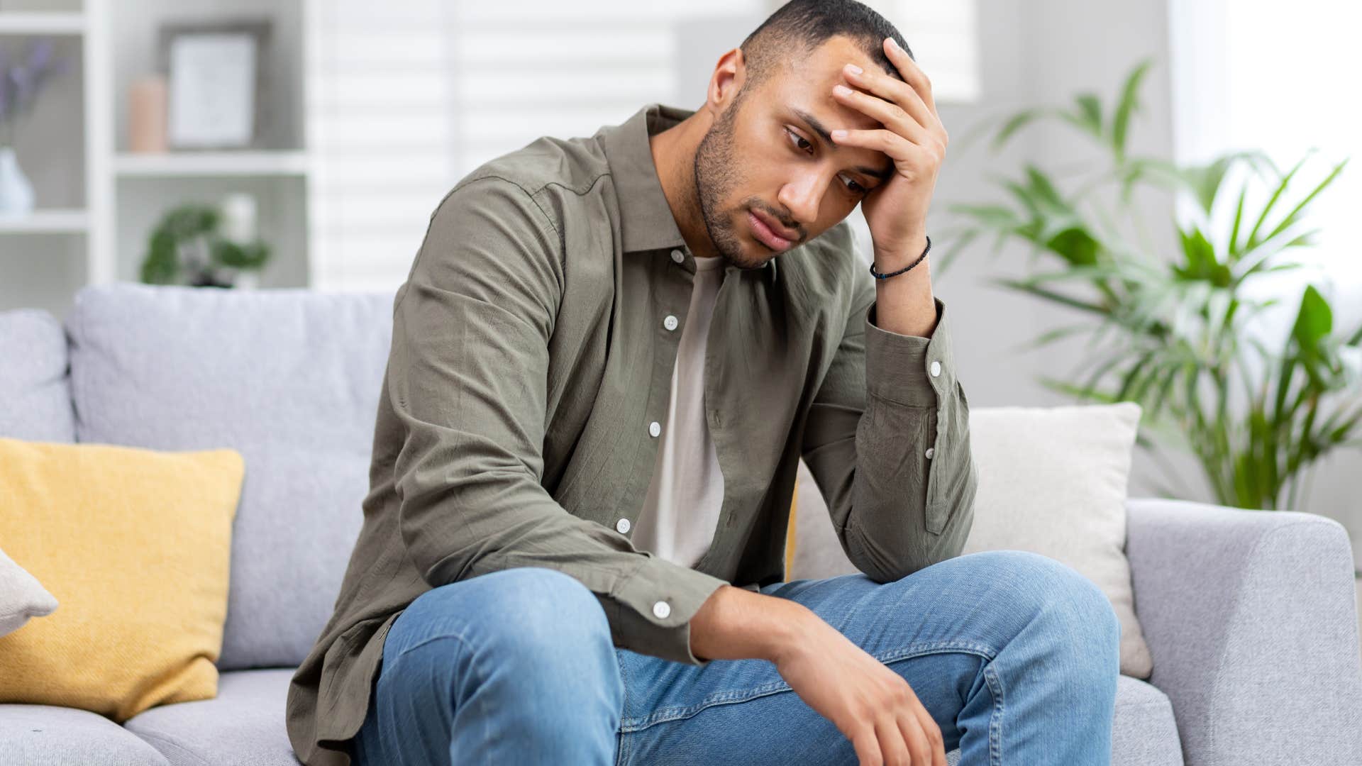upset man sitting on couch