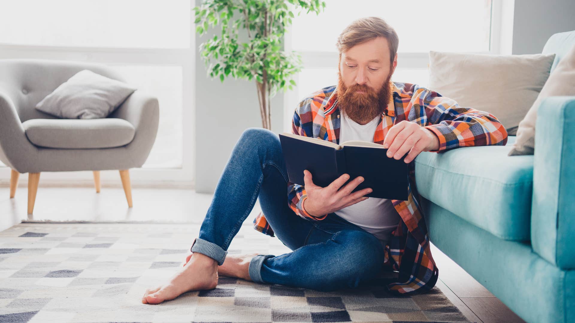 man reading book on floor preferring comfort